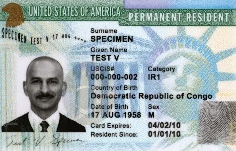 US Permanent Resident Card with specimen details and Statue of Liberty background.