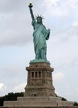 Statue of Liberty against a cloudy sky.