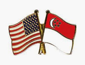 US and Singapore flags crossed.