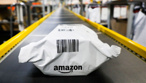 Amazon package on a conveyor belt in a warehouse.