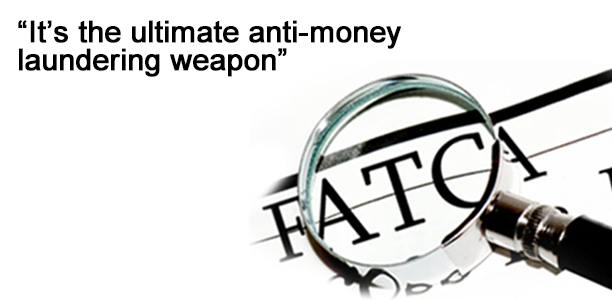 Magnifying glass over the word FATCA on a document. Text reads "It's the ultimate anti-money laundering weapon".