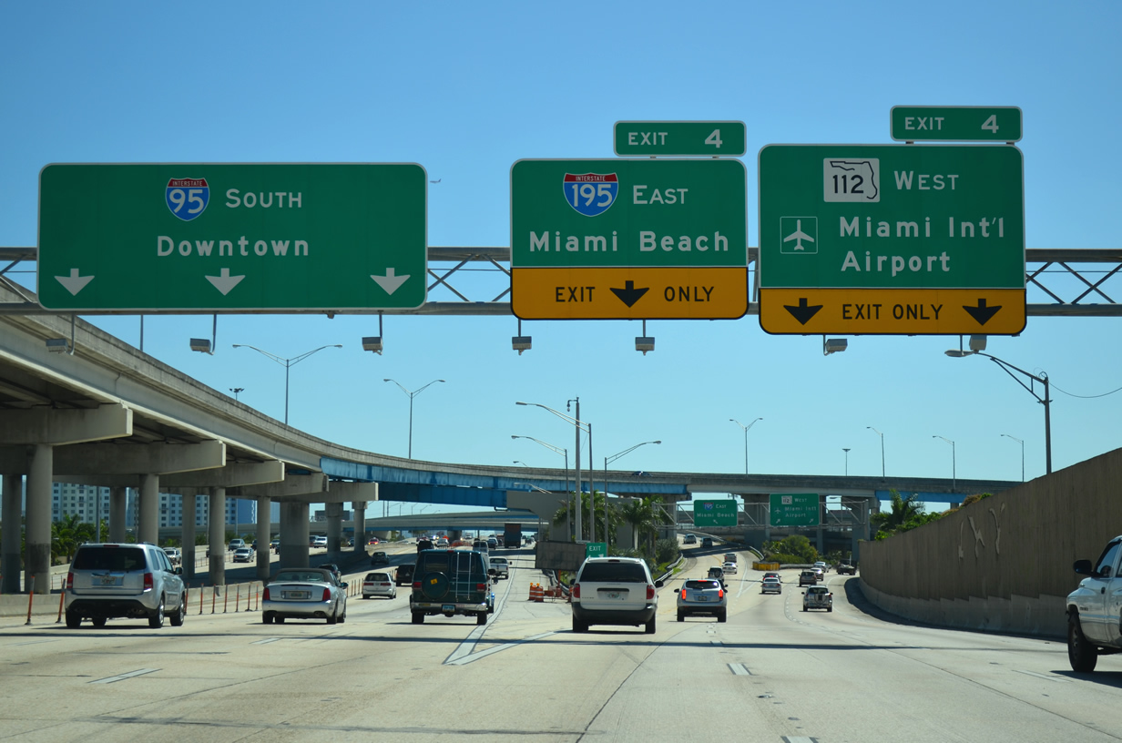 Highway signs for I-95 South Downtown, I-195 East Miami Beach, and I-112 West Miami International Airport.