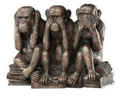 Three monkeys statue covering ears, eyes, and mouth.