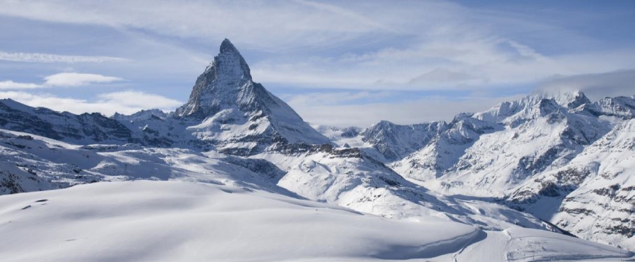 Snow-covered mountains with a prominent peak resembling the Matterhorn.