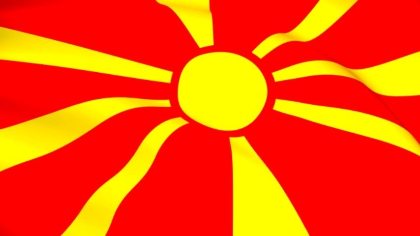 Flag of North Macedonia with a yellow sun on a red field.